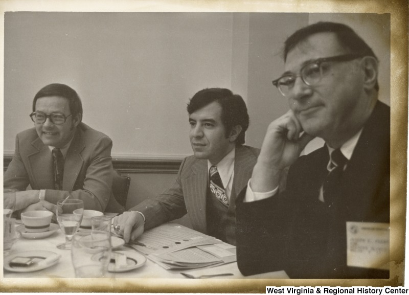 Congressman Nick Rahall II (center) having a mean with two unidentified men.